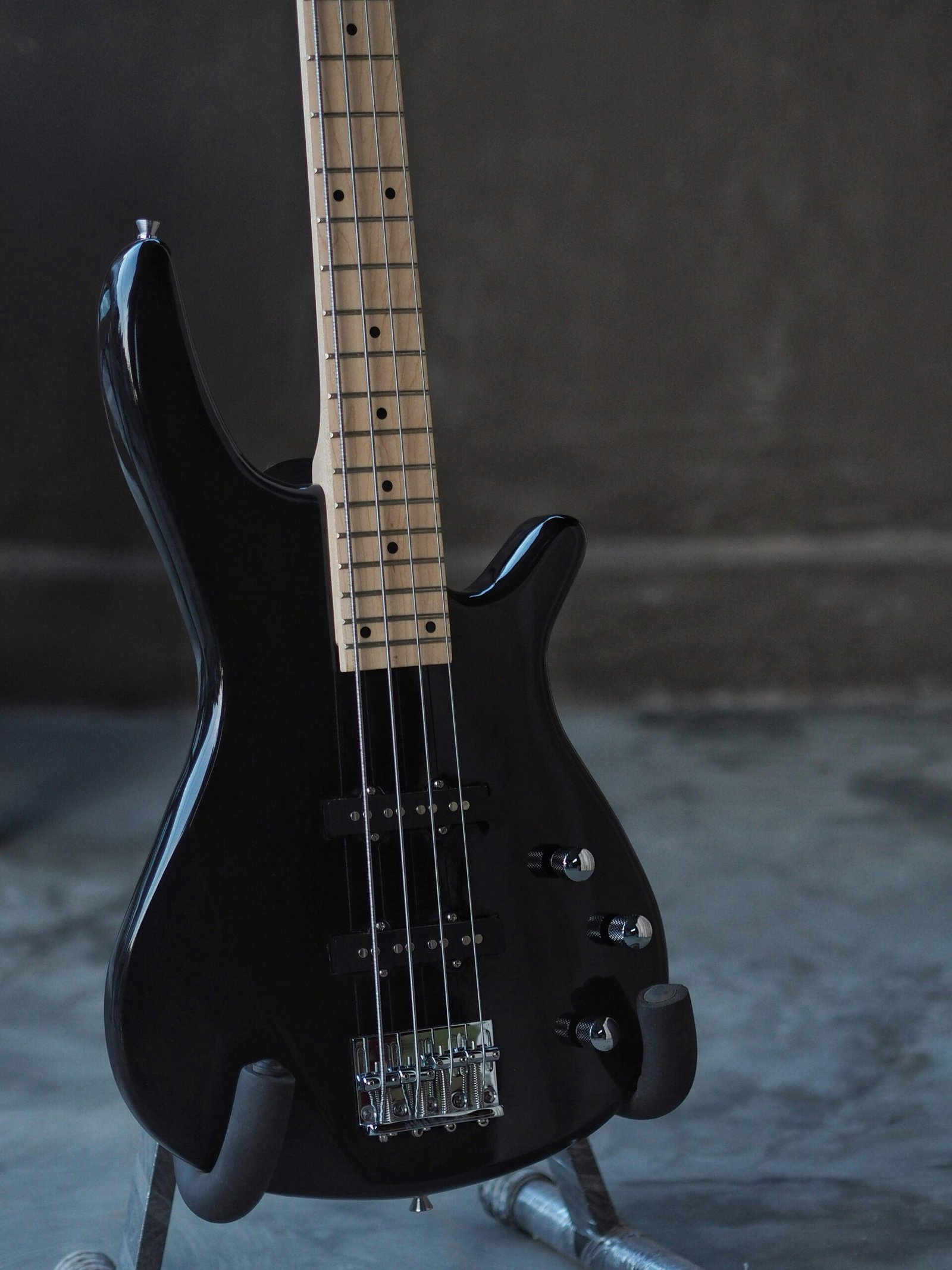 black electric guitar on black and white textile